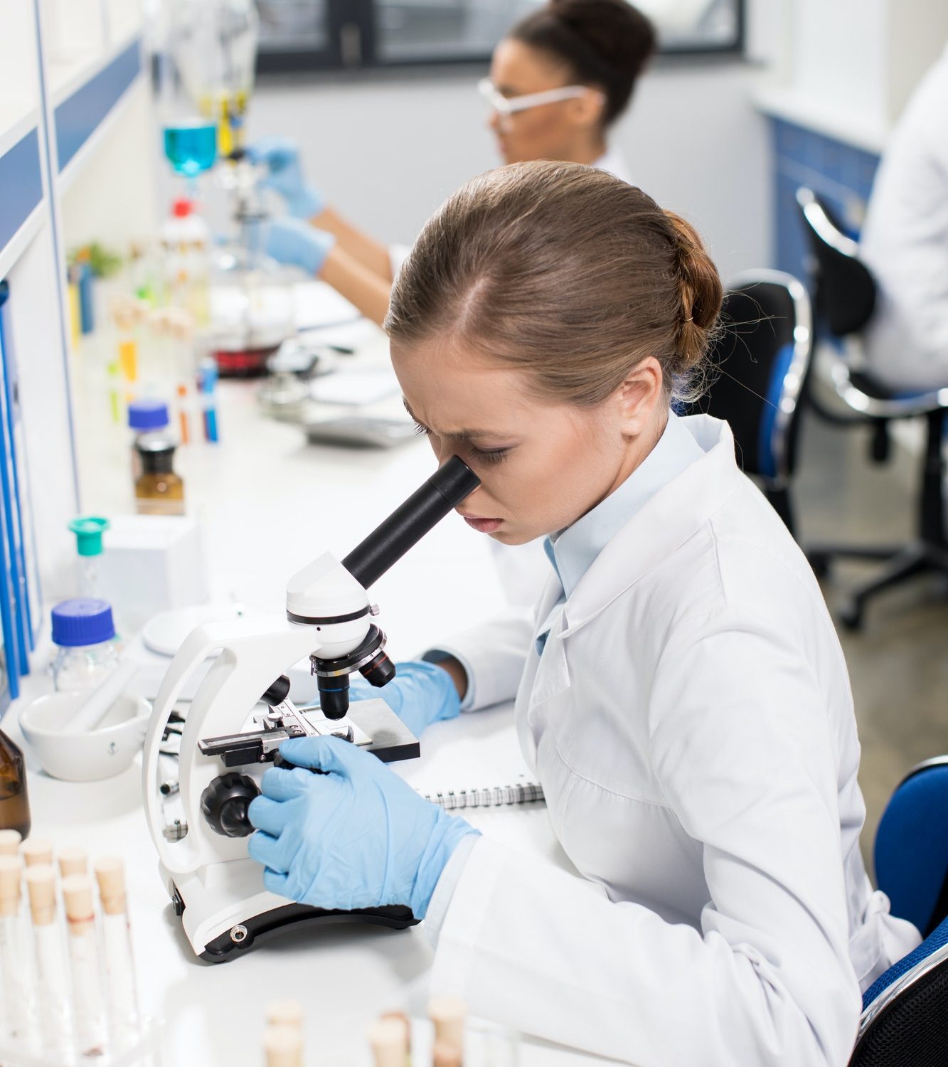 focused-young-scientist-working-with-microscope-in-research-laboratory-2